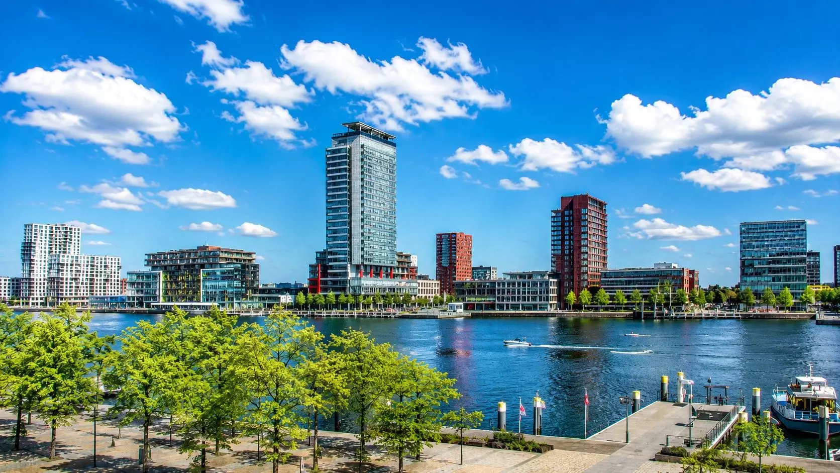Verhuisbedrijf Almere | Veilig en Zorgeloos Verhuizen Modern stadsbeeld aan het water in Almere op een zonnige dag